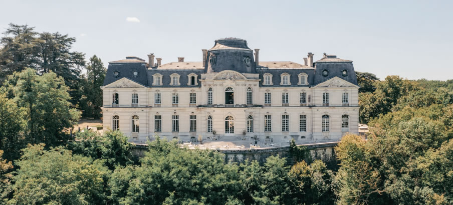 Elegant château surrounded by lush greenery.